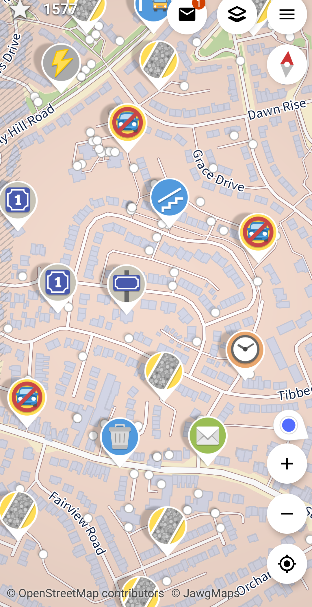 The Street Complete phone app for collecting OpenSteetMap data in the field. It shows a digital map of a residential area with icons showing where data is missing or needs updating.