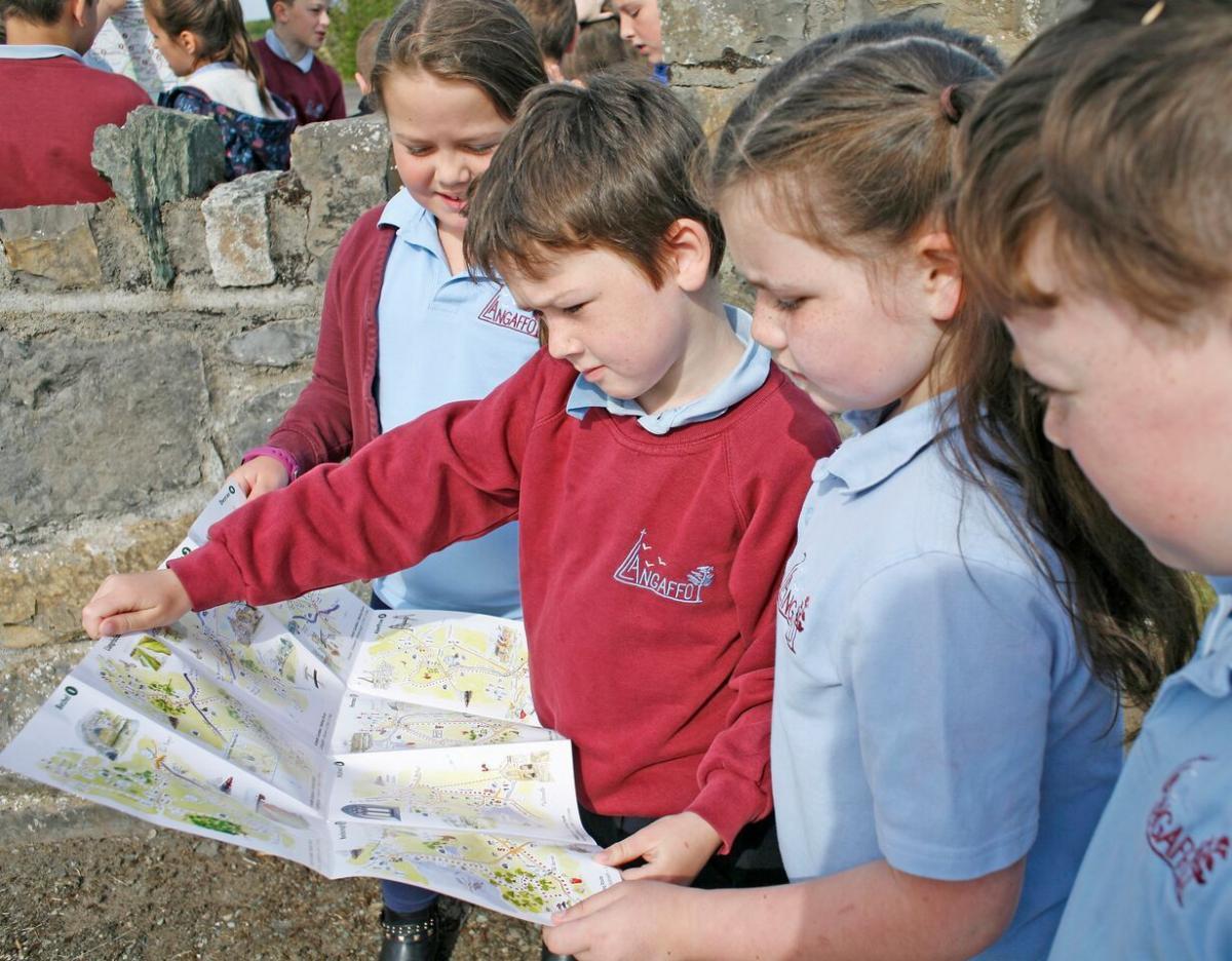 School children reading a map